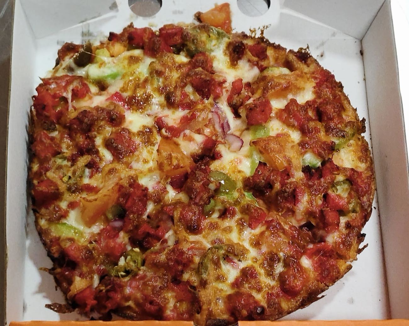 A freshly baked, loaded stone-baked pizza from Grillin Xpress, Manor Park