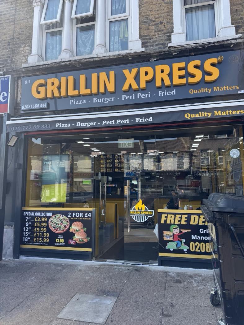 The Grillin Xpress shopfront on Romford Road in daylight, yellow sign on black