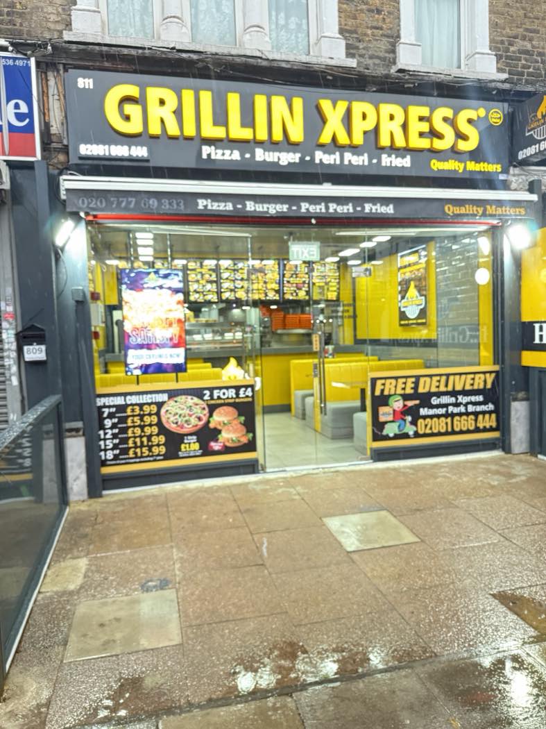 The Grillin Xpress shopfront lit up at night on Romford Road, Manor Park